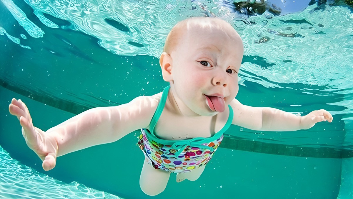 Em bé ngồi trên ghế, đôi chân bé xíu đung đưa