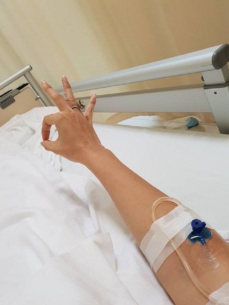 Tay bệnh nhân được cố định để truyền dịch, dây truyền dẫn từ túi dịch.