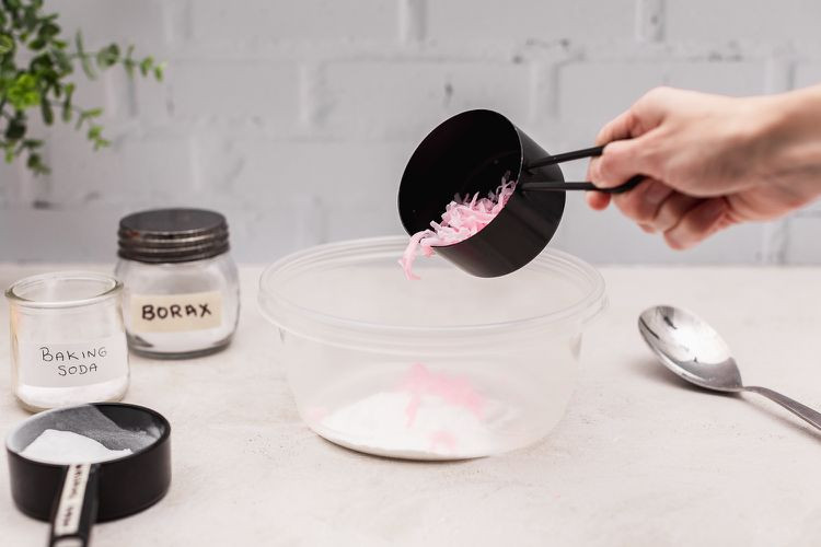 Các vảy xà phòng Zote được đổ vào hộp nhựa cùng với baking soda, borax và washing soda